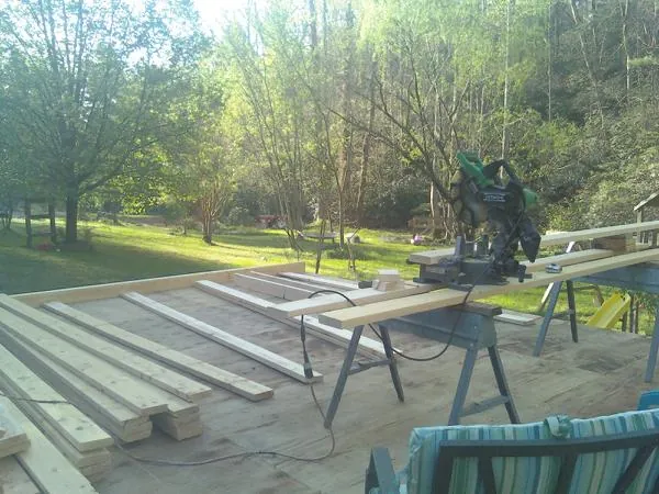 Miter saw and framing lumber on a deck under construction in North Providence