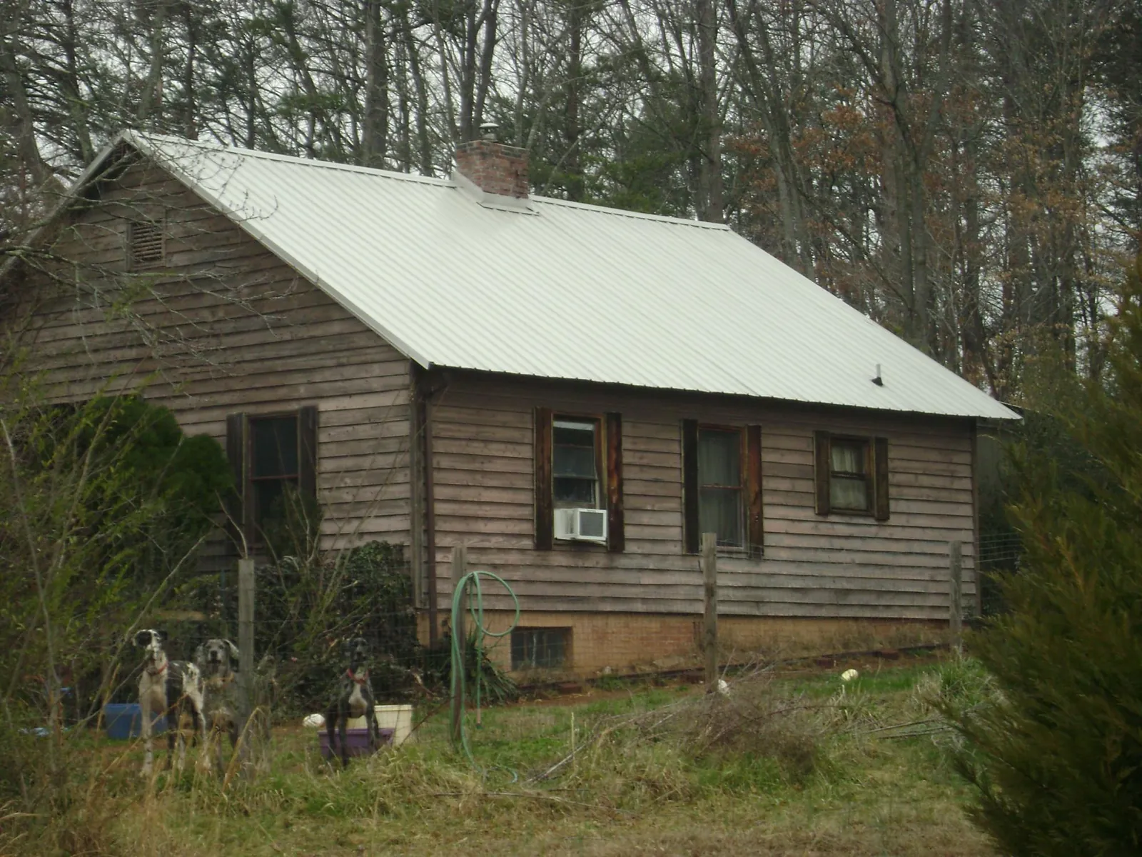 White metal roof on an old wood sided farmhouse, from a Metal Roof Installation job in North Providence